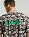 Model wearing Cuera Oncourt Breathe Camou T-Shirt in Camou Green Print, back studio view