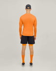 Model wearing Cuera Oncourt LS Layer T-Shirt in Orange, back studio view