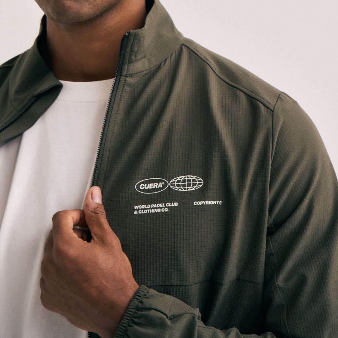 Model wearing Cuera Active Cuera Track Jacket in Army, close-up detail on model
