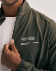 Model wearing Cuera Active Cuera Track Jacket in Army, close-up detail on model