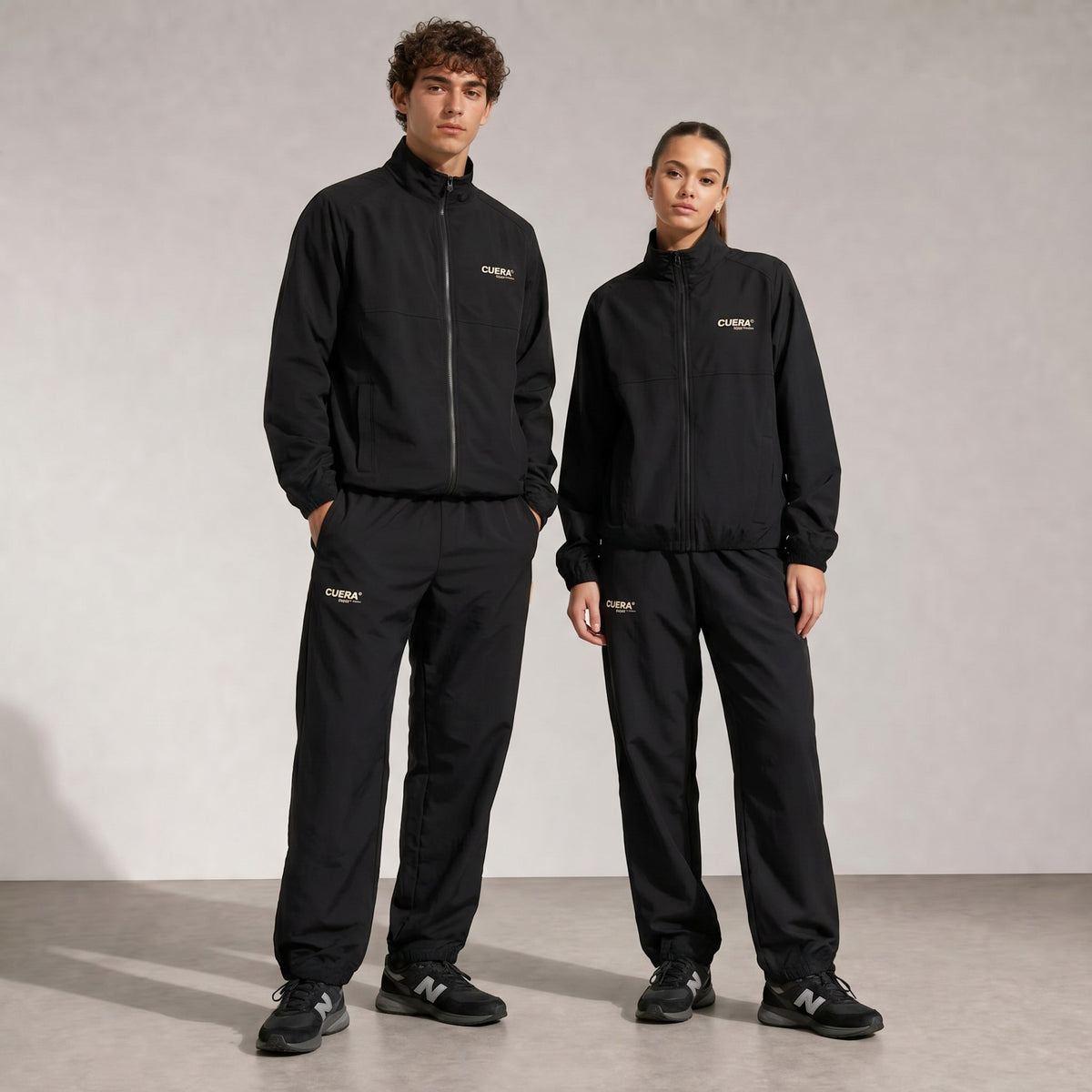 Model wearing Cuera Active Cuera Track Pants in Black, front studio view
