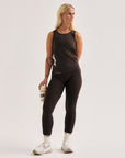 Model wearing Cuera Active Cuera Zip Cardigan & Active Logo Tights Long Combo, lifestyle action shot on the padel court