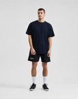 Model wearing Cuera Oncourt Breathe T-Shirt in Black, lifestyle action shot on the padel court